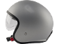 Casco da moto grigio con visiera trasparente, vista laterale.