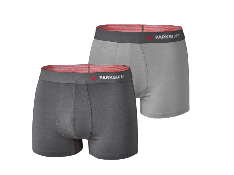 Due boxer da uomo in cotone, uno grigio scuro e uno grigio chiaro, con elastico rosso.