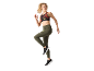 Donna con reggiseno sportivo stampato e leggings verdi con tasche.