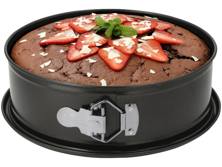 Torta al cioccolato in uno stampo a cerniera, decorata con fragole, menta e cioccolato bianco.