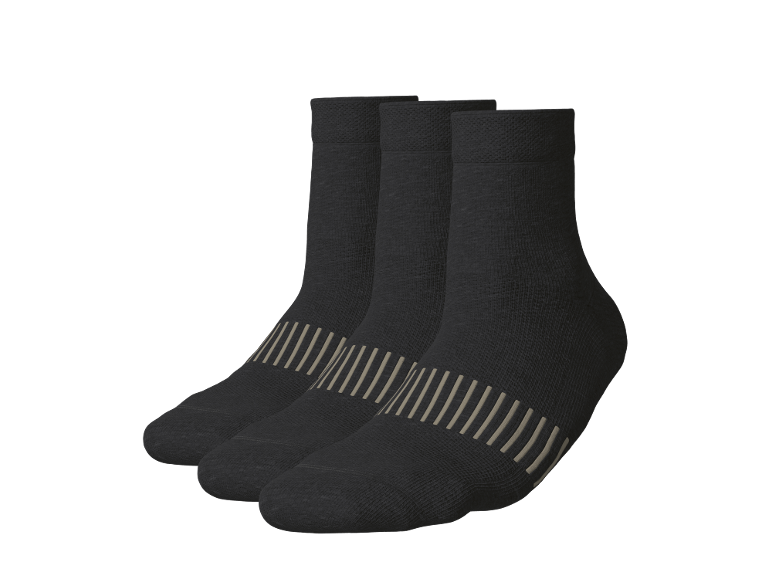 Tre paia di calzini corti neri con strisce beige.