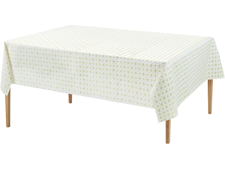 Tovaglia bianca con motivo geometrico verde e beige su un tavolo di legno.