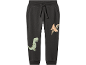 Pantaloni per bambini grigio scuro con dinosauri e un pterodattilo.