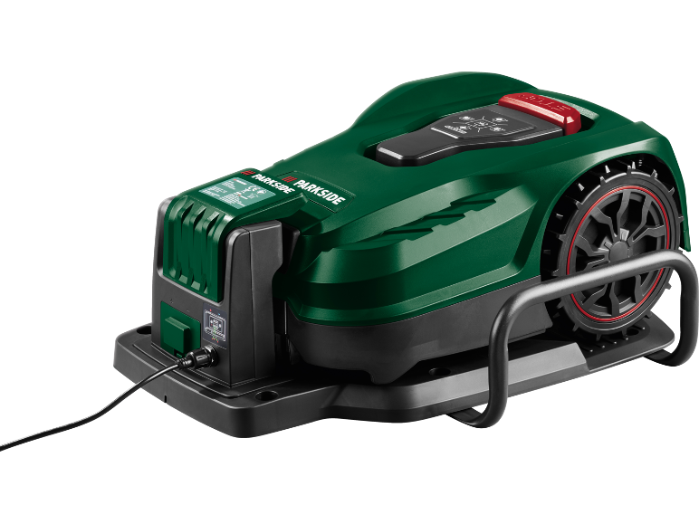 Robot tagliaerba verde con ruote nere e accenti rossi, in carica su una base nera.