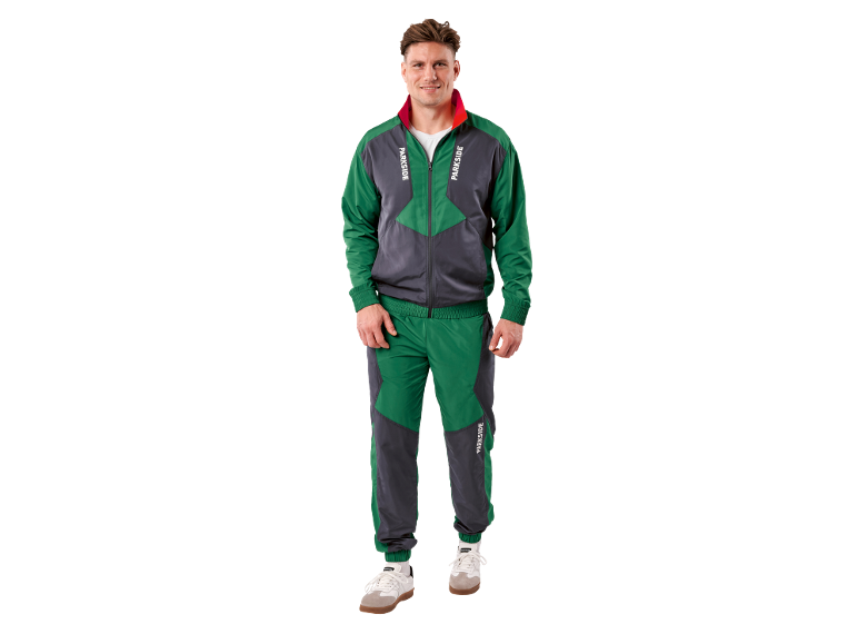 Uomo in tuta verde e grigia con scritta 'PARKSIDE' e sneakers bianche.