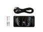 Docking station nera con cavo USB, viti e tasselli su sfondo nero.