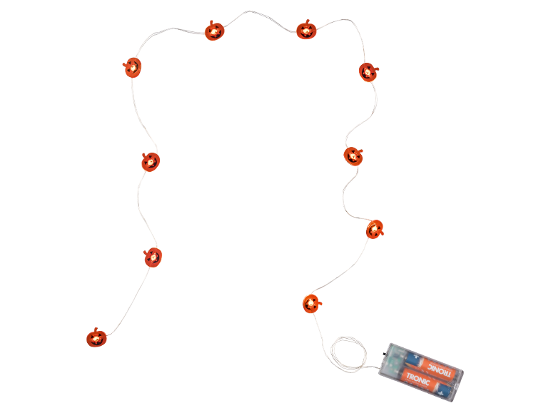 Luci a stringa a forma di zucca di Halloween con pacco batterie su sfondo nero.