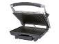 Grill elettrico aperto con piastre nere a coste e manico argentato.
