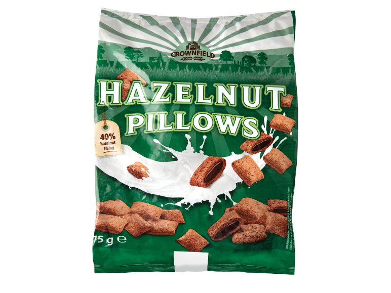 Sacchetto di cuscini alla nocciola con il 40% di ripieno, con schizzi di latte e paesaggio agricolo.