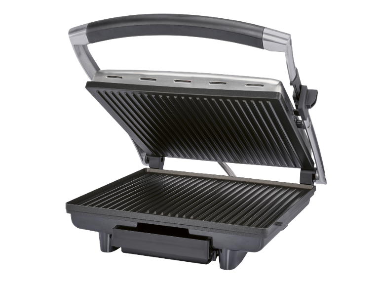 Grill elettrico aperto con piastre nere a coste e manico argentato.