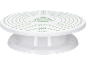 Piatto girevole bianco per decorare torte con misurazioni verdi e disegno di torta.