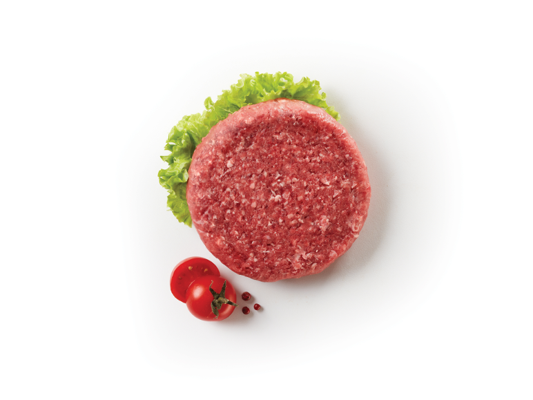 Hamburger crudo con lattuga e pomodorini su sfondo bianco.