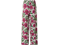 Pantaloni a gamba larga con stampa floreale di fiori di ibisco fucsia e foglie verdi.