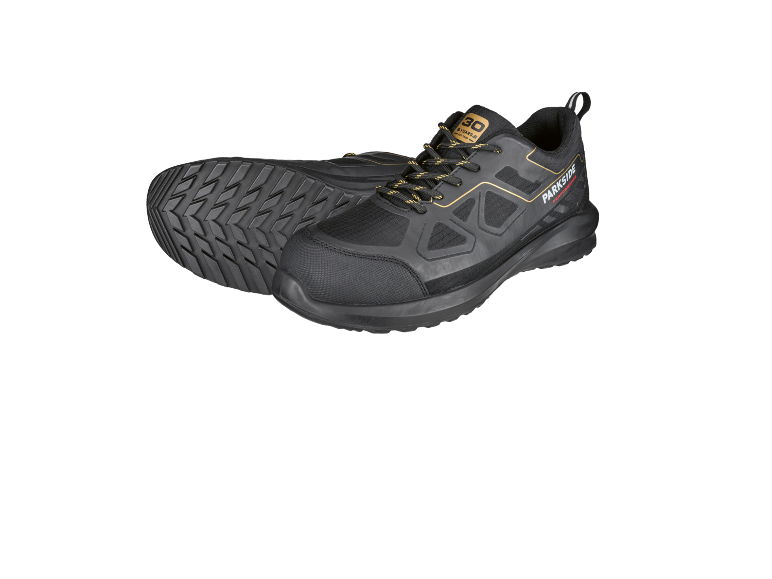 Scarpe da lavoro nere con lacci gialli e suola antiscivolo.