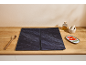 Protezioni scure per piano cottura su un bancone in legno con utensili da cucina.