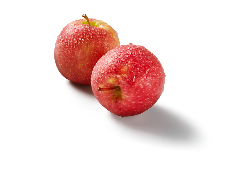 Due mele rosse succose con goccioline d'acqua su sfondo bianco.