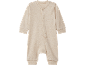 Tutina neonato beige a maniche lunghe in cotone biologico con bottoni a pressione.