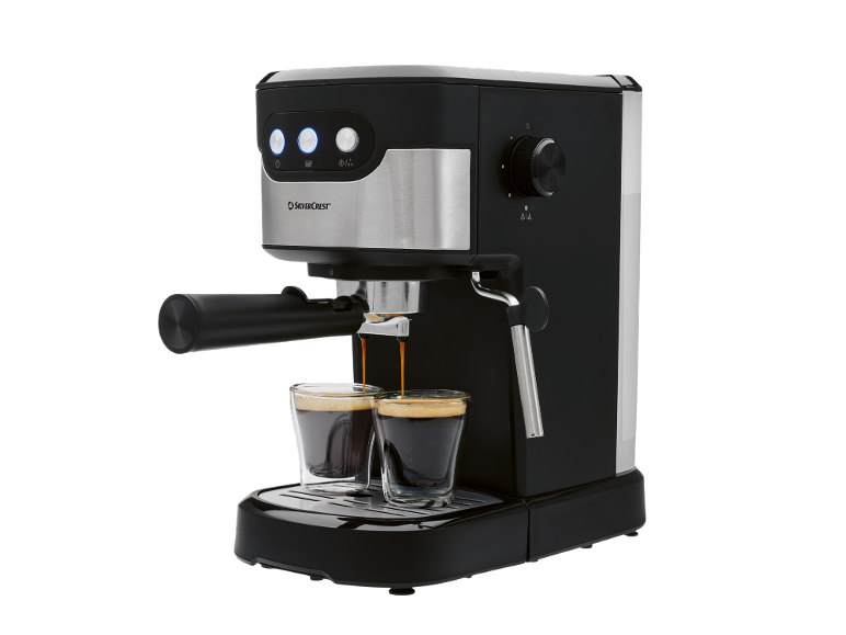 Macchina da caffè espresso nera che prepara due tazze di caffè.