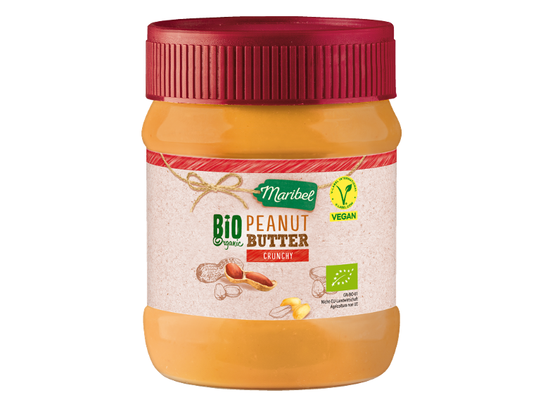 Burro di arachidi croccante biologico in un barattolo con coperchio rosso, con etichetta vegana.
