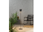Lampada da terra con paralume geometrico in un interno moderno con pianta e sedia