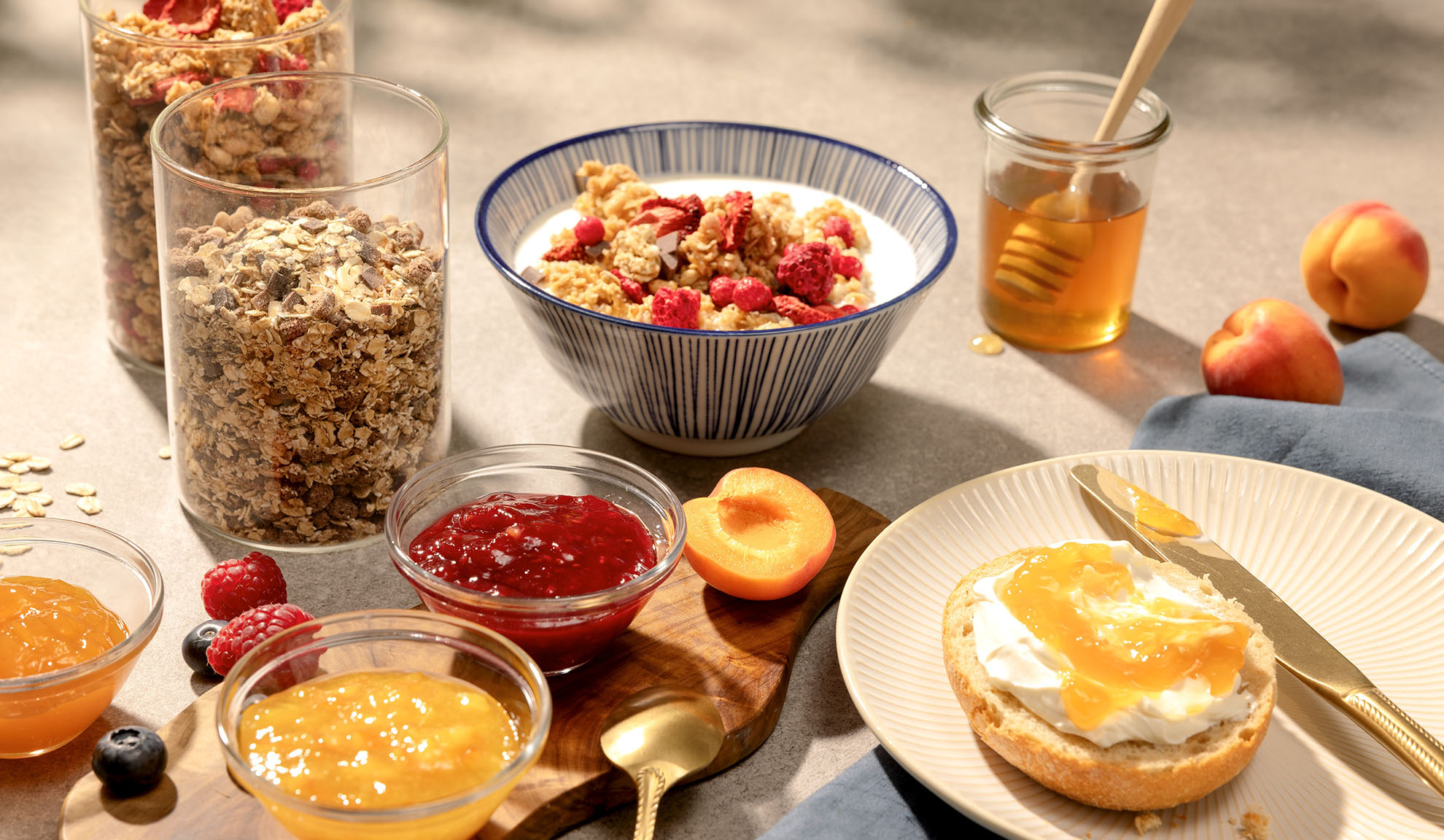 Colazione con granola, miele, marmellata e frutta fresca.