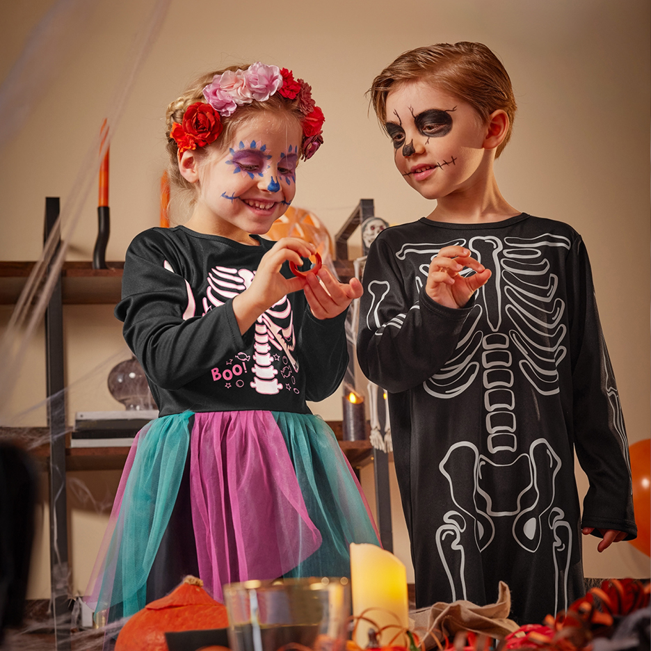 Due bambini in costume da scheletro con il viso dipinto per Halloween.
